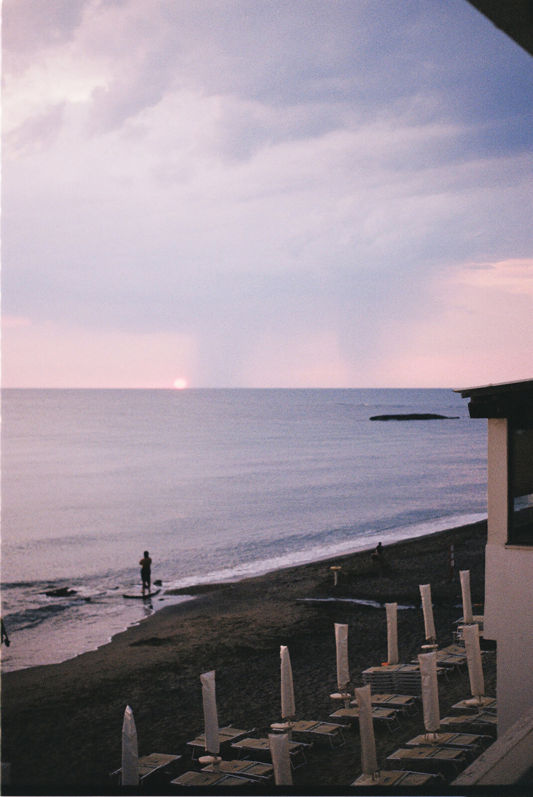 An empty beach pier at dusk under a pastel sky